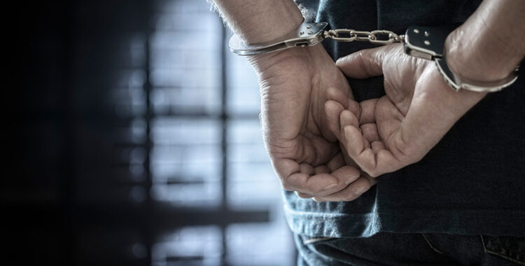Man arrested in handcuffs