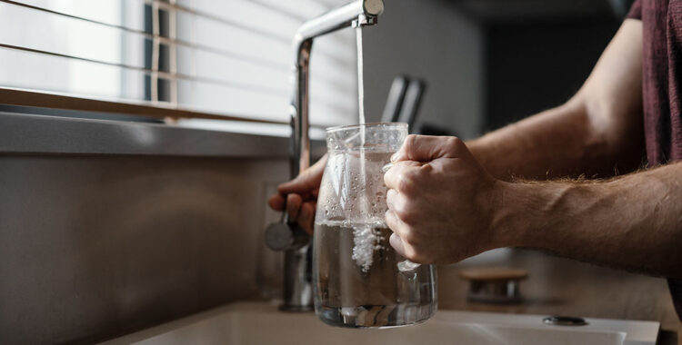 Man filling a pitch with water